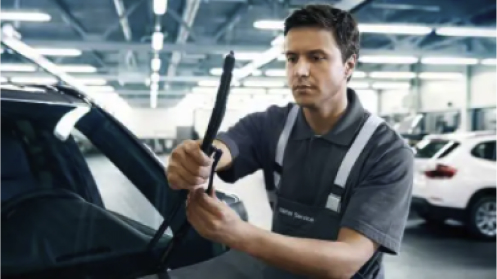 Technician changing wiper blade